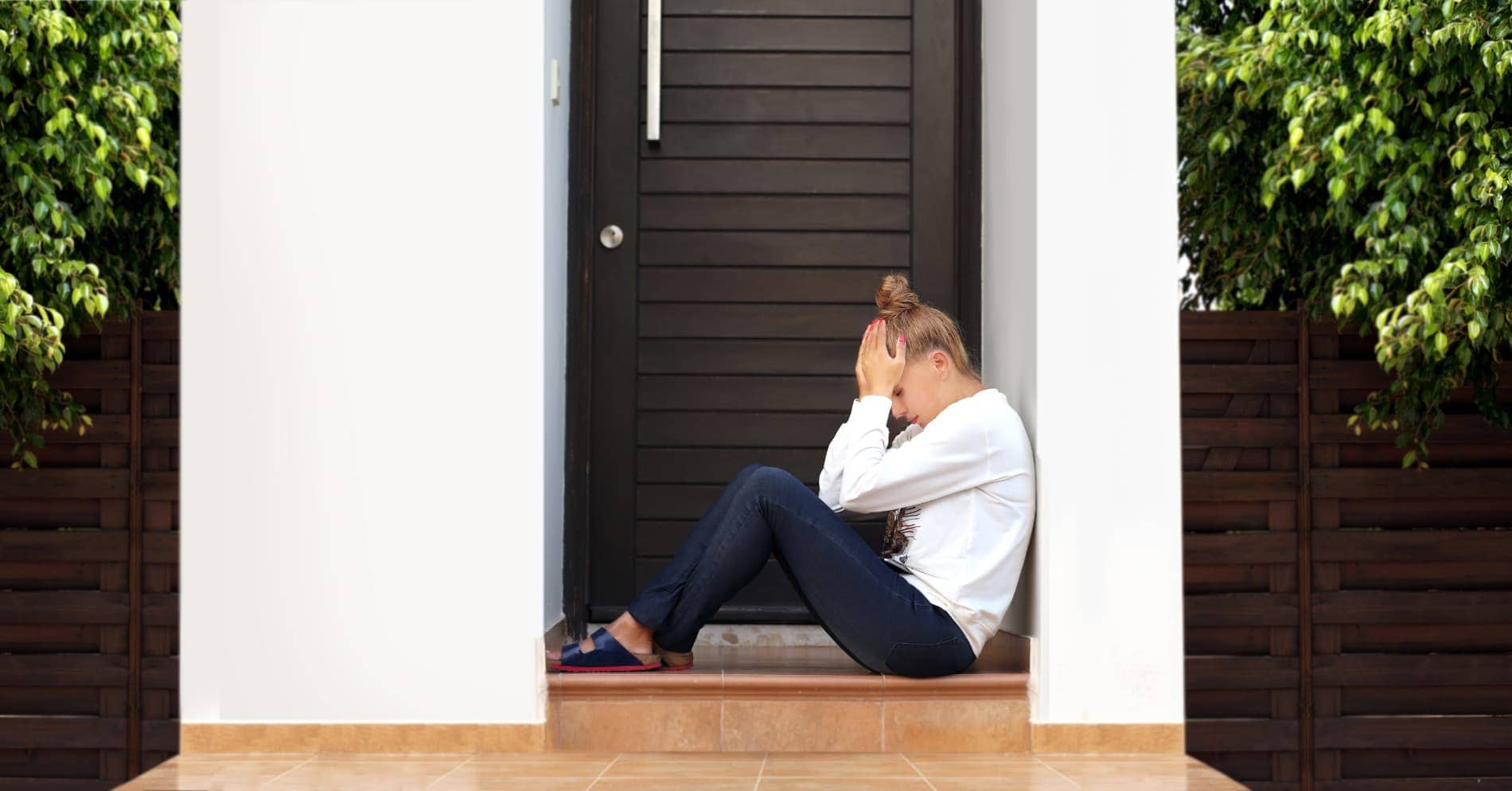 mujer preocupada por la cerradura de la puerta cerrada